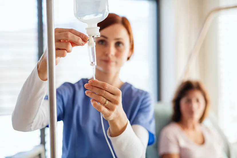 Provider setting up the IV with saline fluid