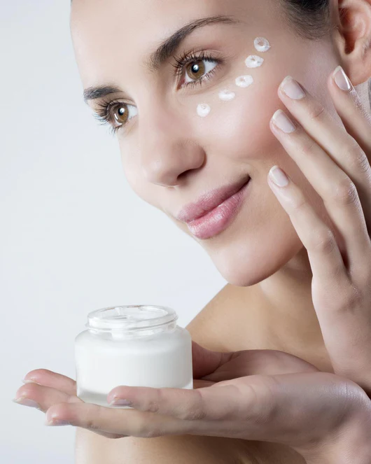 Women applying anti aging cream.